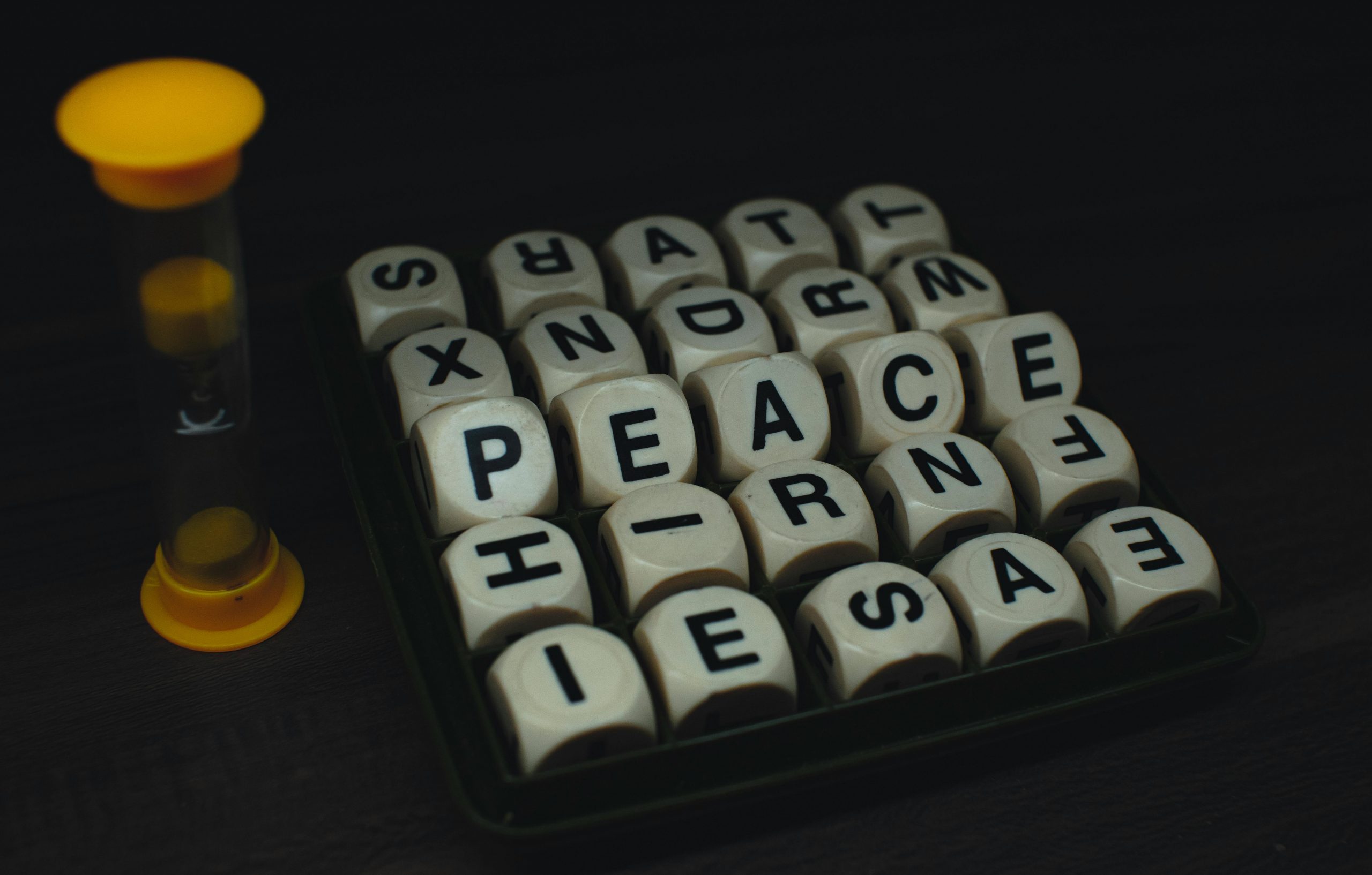 Boggle set next to an hourglass