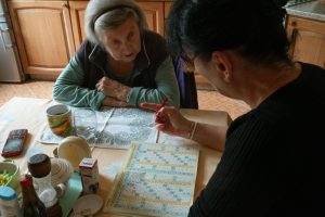 elderly women solving a crossword puzzle